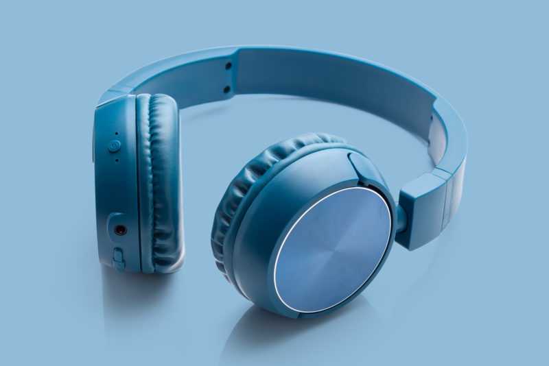 bluetooth blue headphone on blue background studio packshot equipment