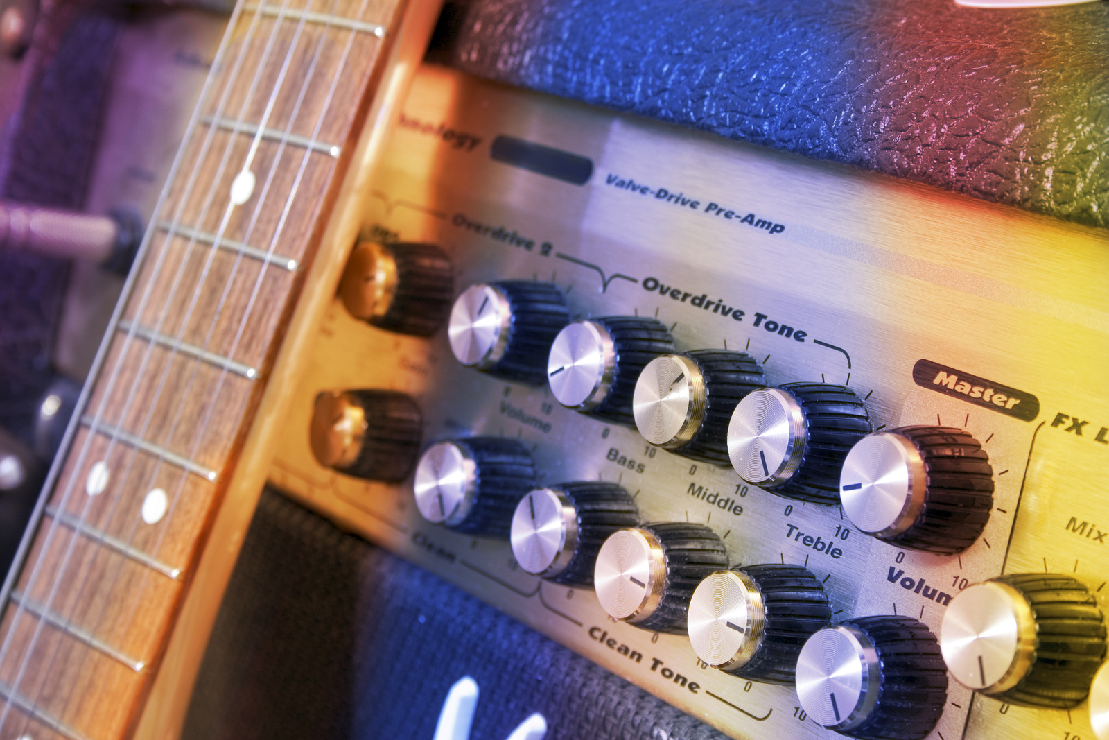 Guitar and amp with coloured lighting.