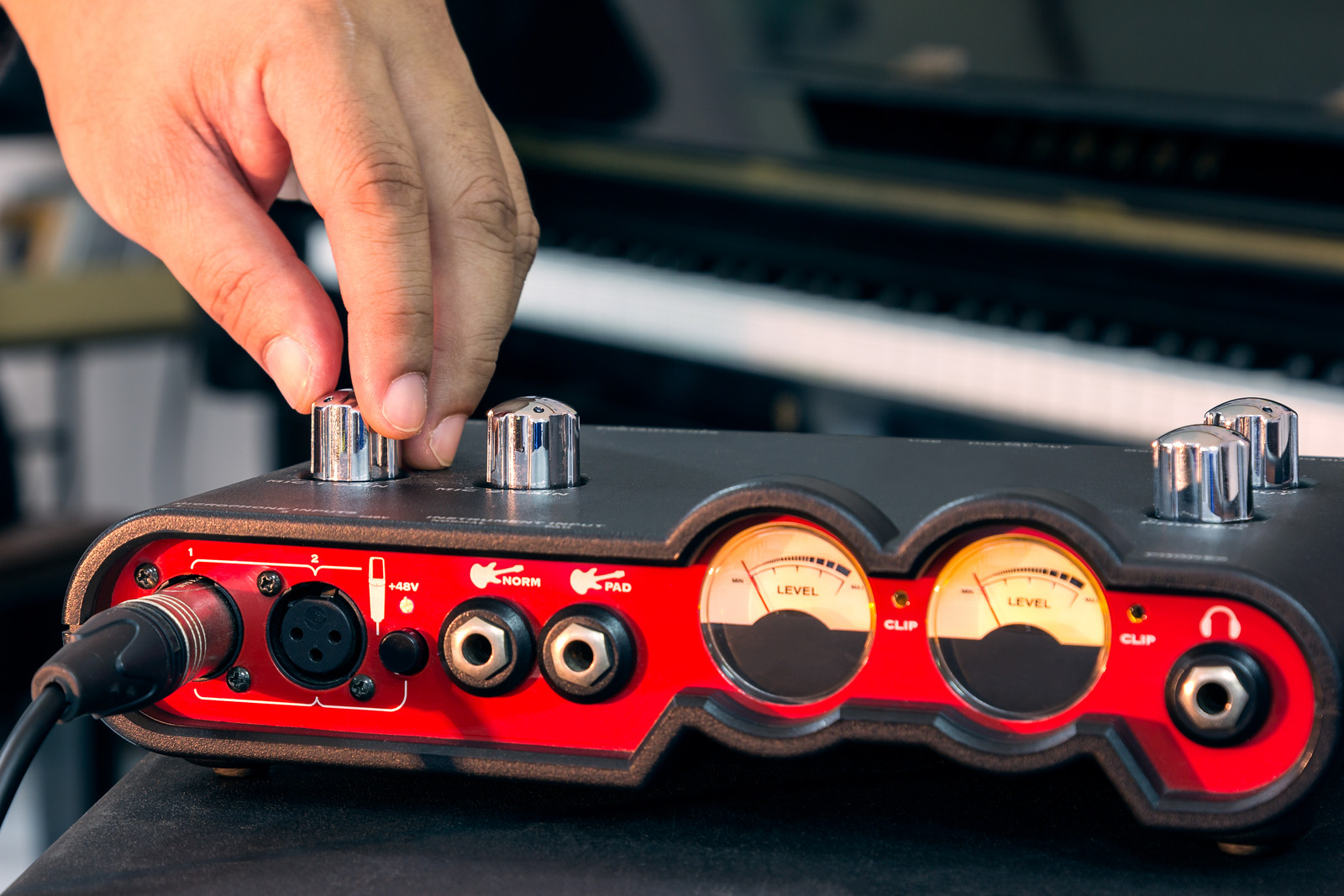 Hand adjust volume of the audio interface for Home recording, external sound card.