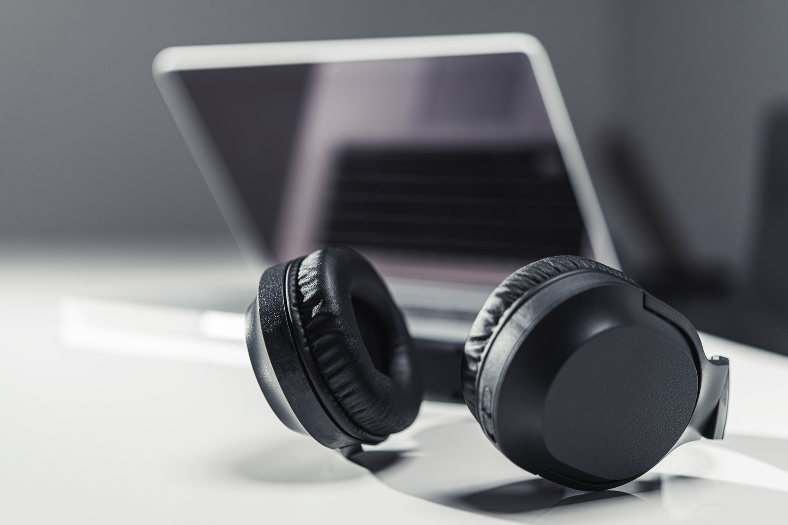 Modern Laptop Computer and Large Professional Wireless Headphones. Online Streaming Technologies Concept.