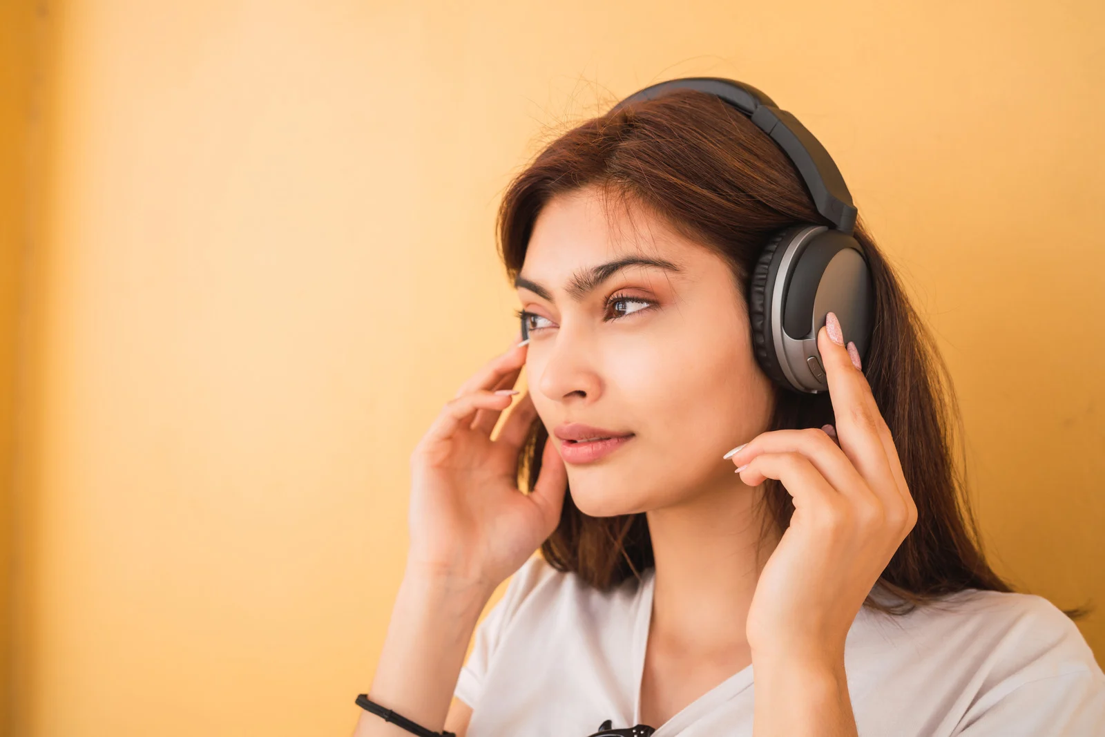 Young Woman Listening to Music Using Headphones