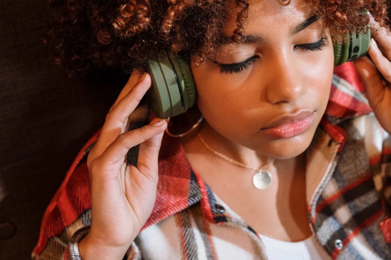 Business woman wearing headphones at home office