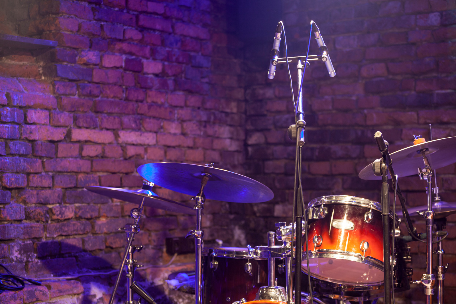 Drum Kit and Microphone on a brick stage