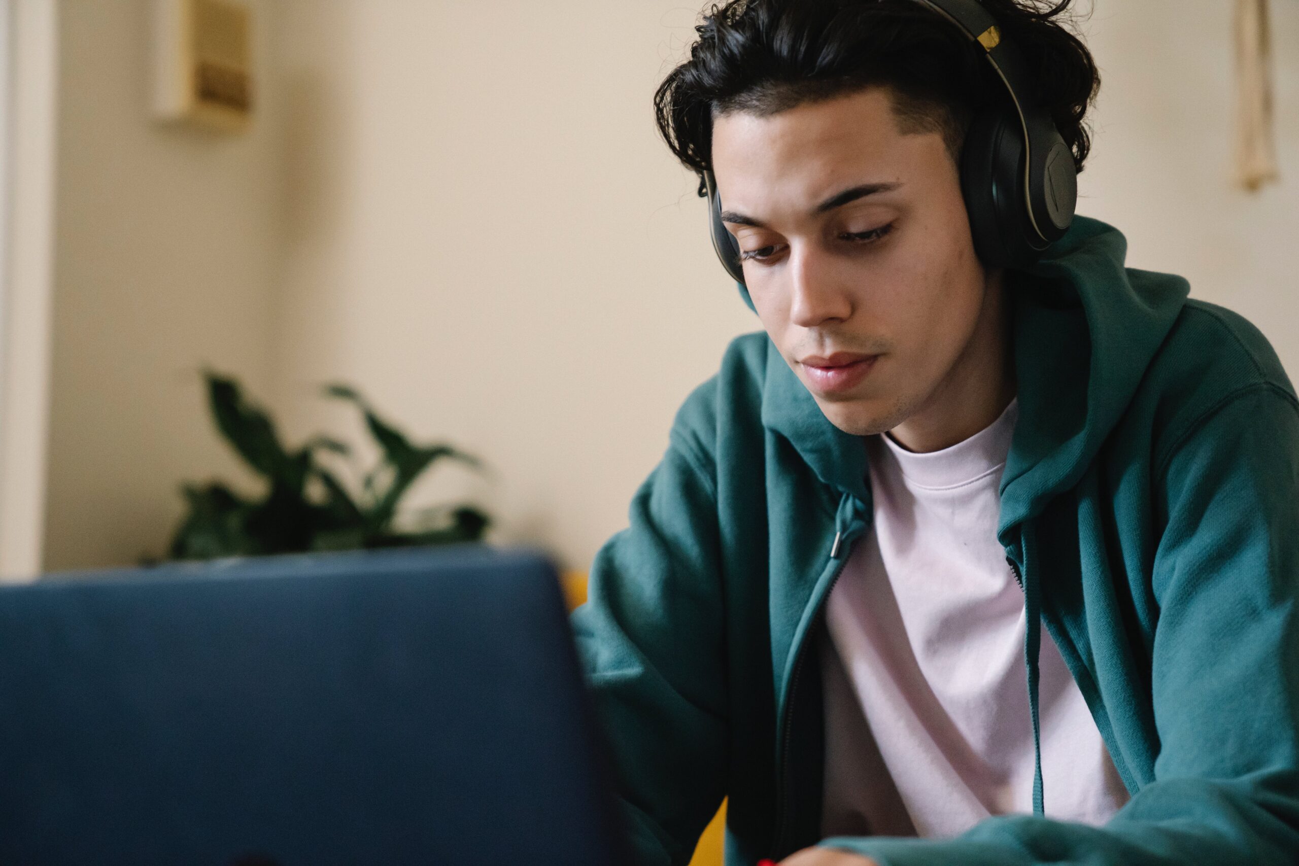 young man using a headphone and a laptop