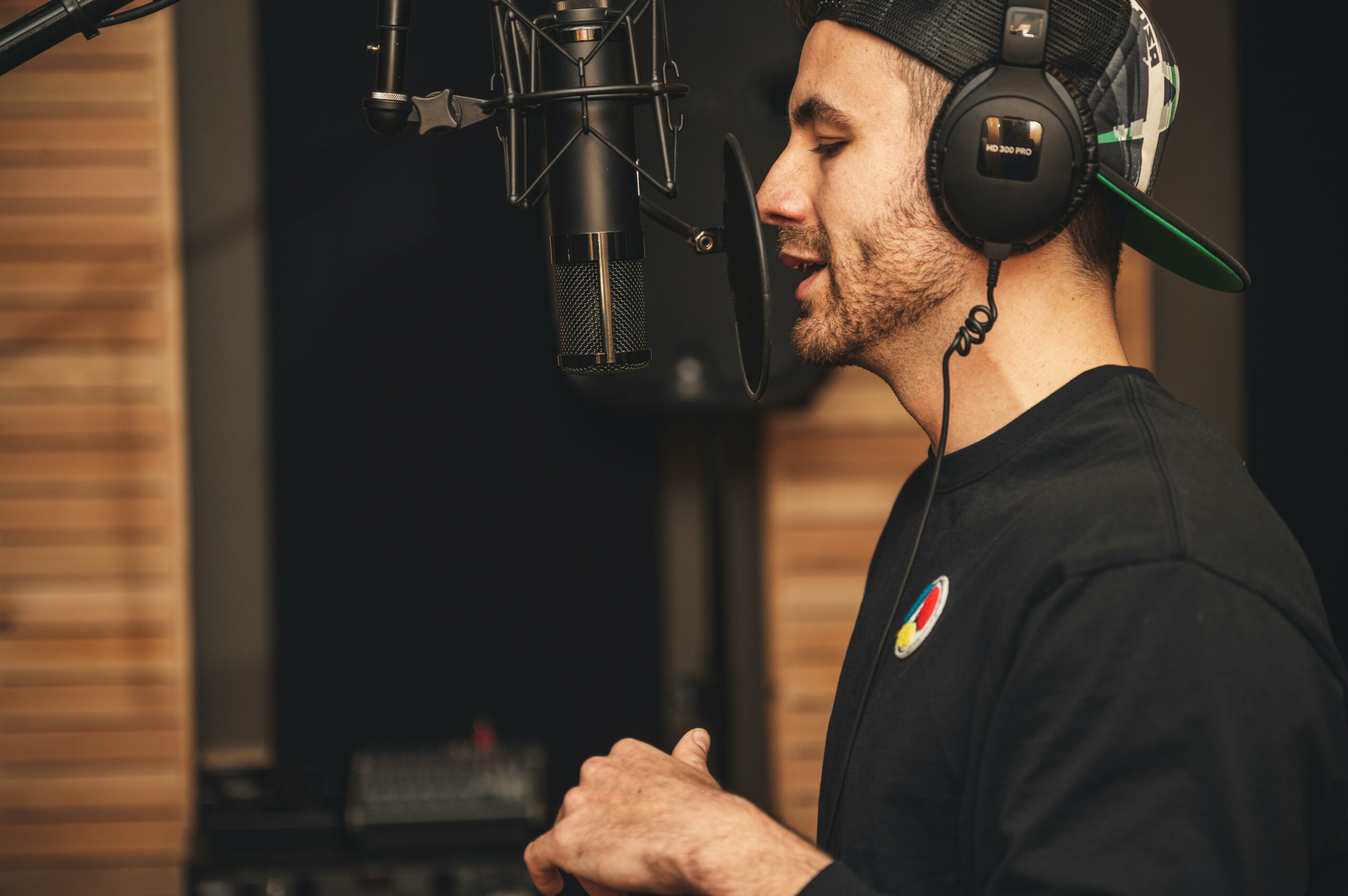 man wearing headphones recording in a studio