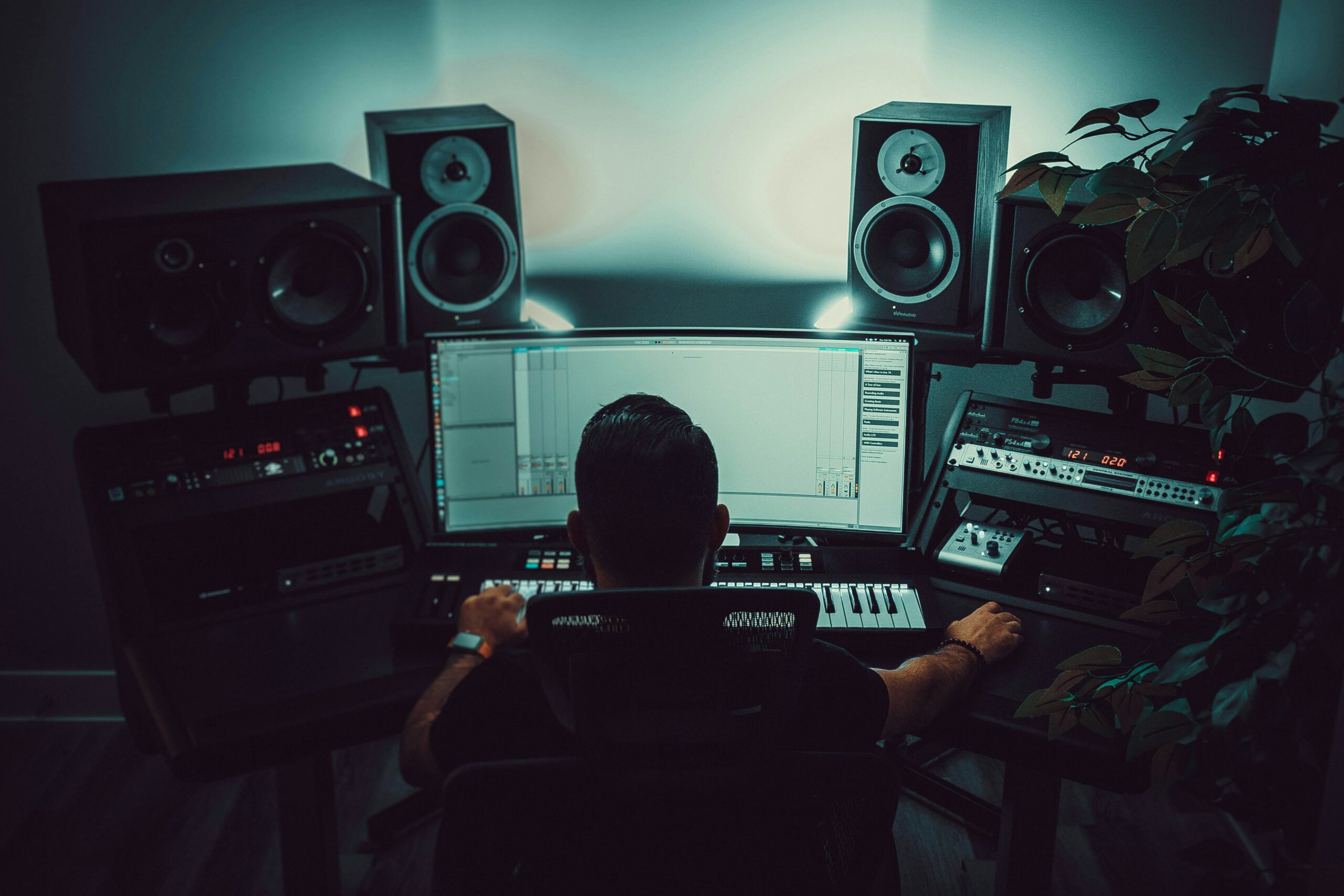 man in front of a monitor inside a music studio